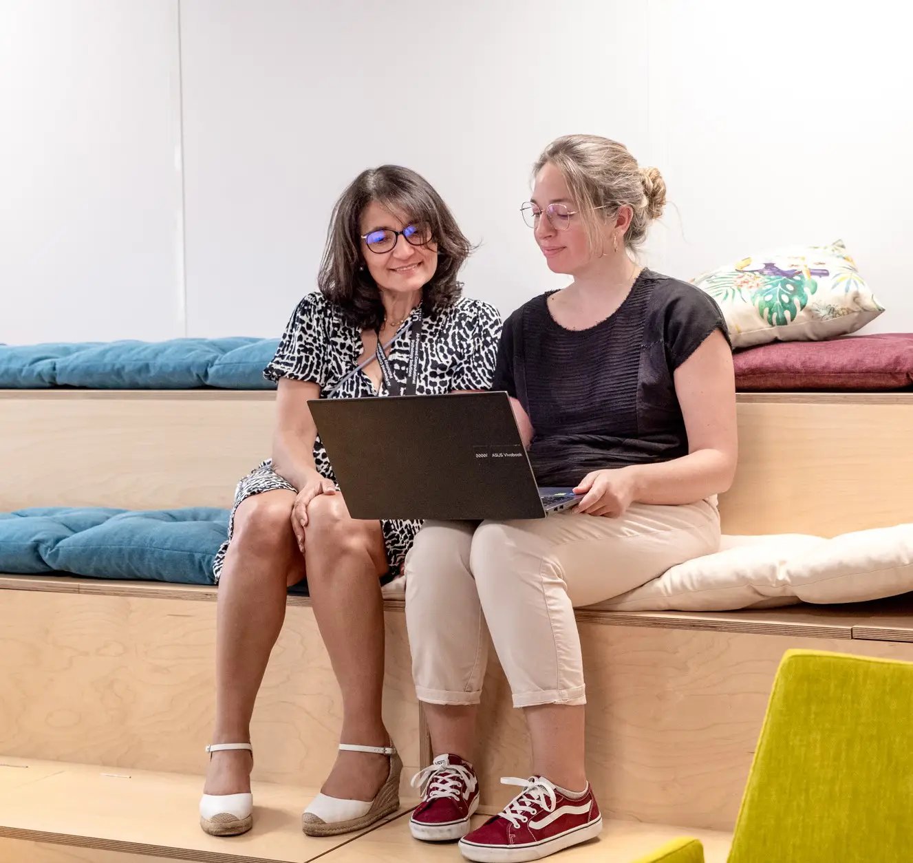 two woman working together on a computer
